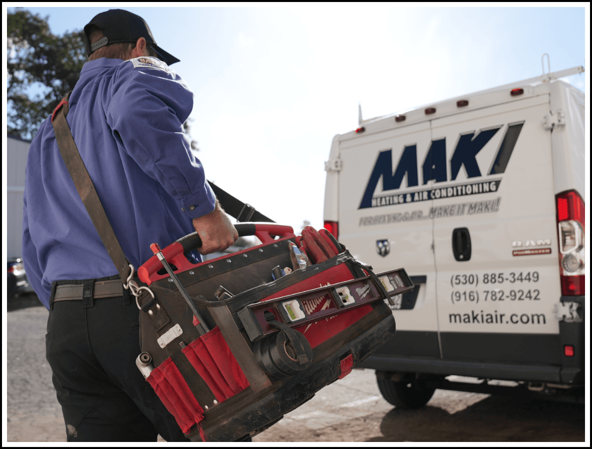 HVAC technician walking to his Maki Heating & Air Conditioning service vehicle at Auburn, CA, office.