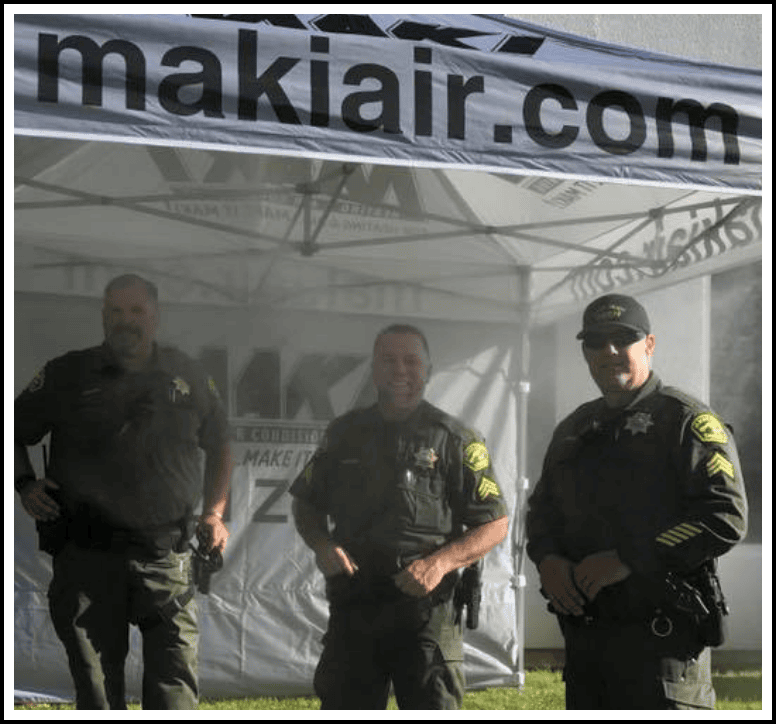 Placer County sheriff with deputies at Maki Heating & Air Conditioning tent for local community event in Auburn, California.