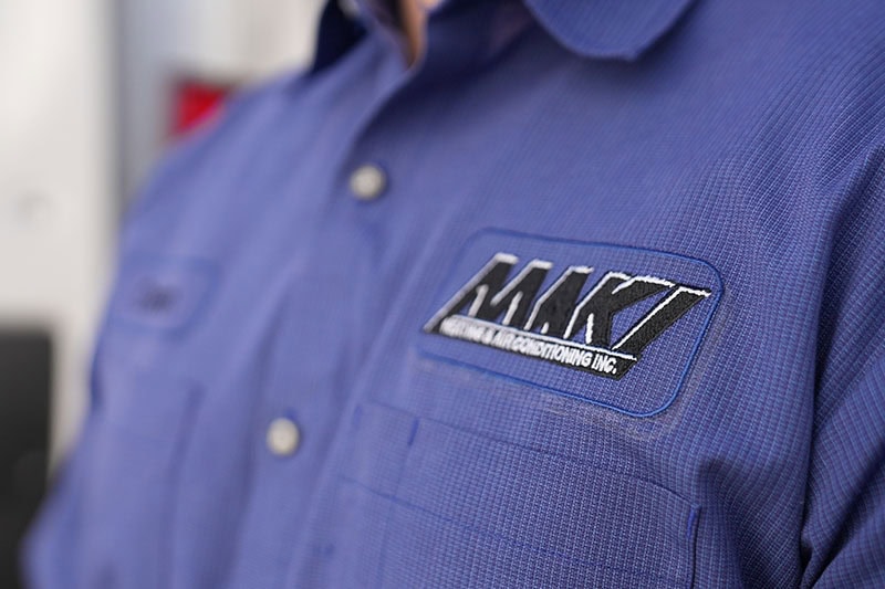 Maki Heating & Air technician shirt.