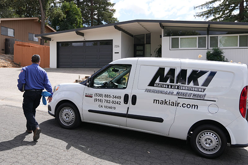 HVAC technician walking up to a home.