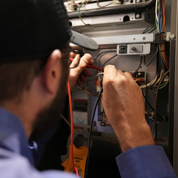Maki Heating & Air Conditioning technician working on an air handler
