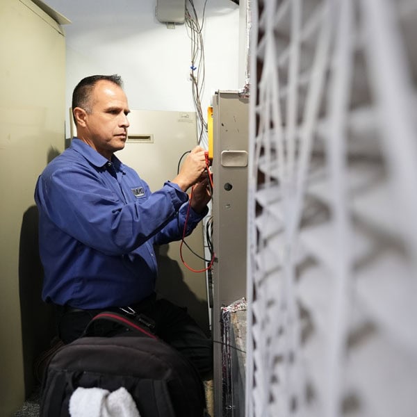 Maki Heating & Air Conditioning technician working on a gas furnace