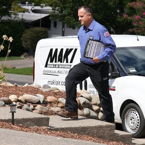 Maki Heating & Air Conditioning technician walking up steps to customer’s home