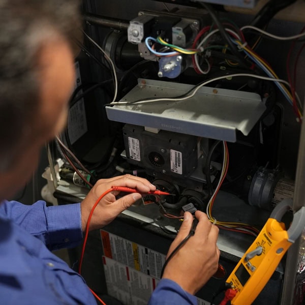 Maki Heating & Air Conditioning technician working on an inside unit